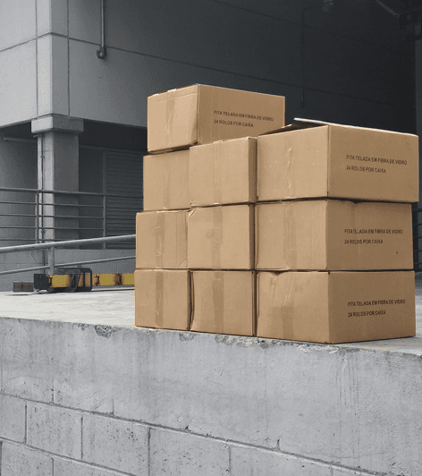 Cardboard boxes stacked on concrete wall